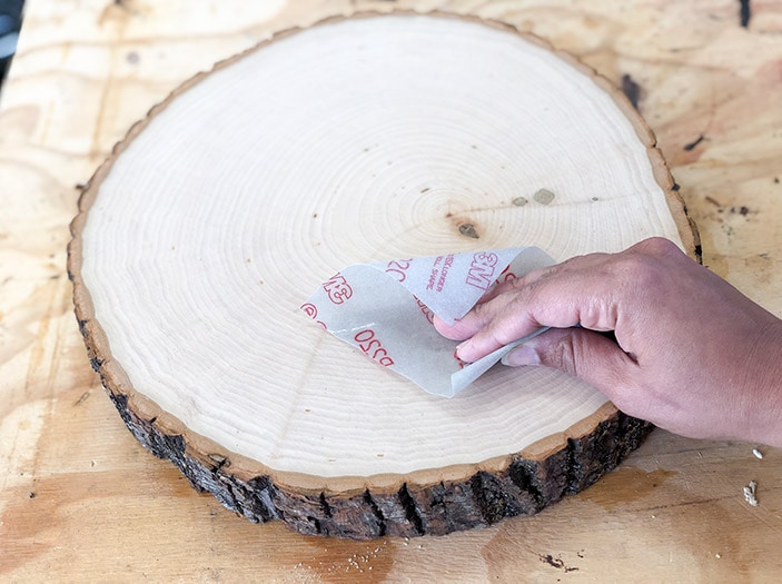 sanding the wood slice