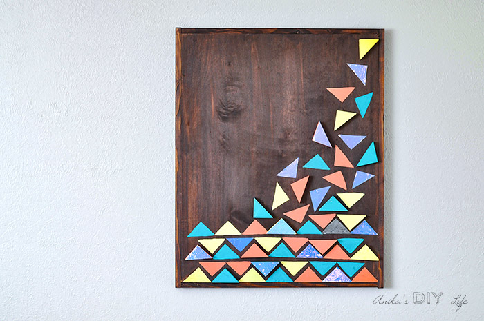 DIY wood wall art with colorful geometric triangles on mounted on wall