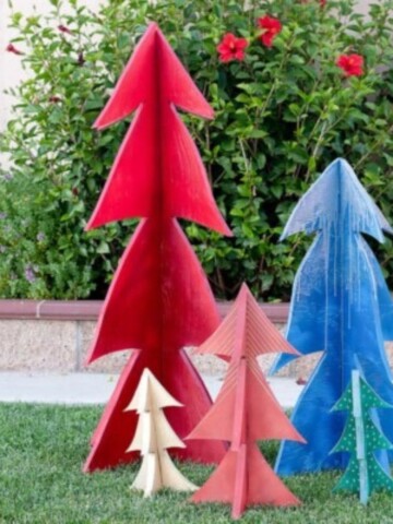 Learn how to make these easy colorful 3-D DIY wooden Christmas Trees using plywood. They are perfect for outdoor yard decor, centerpieces, or even the mantle and can be made using scrap plywood!