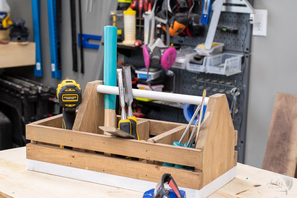 DIY wooden organizer on a workbench in the garage full of tools