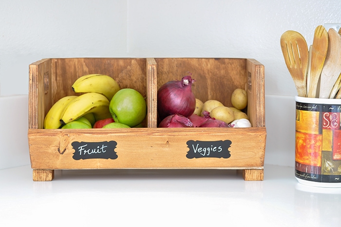 DIY vegetable bins with fruits and vegetables on a kitchen counter