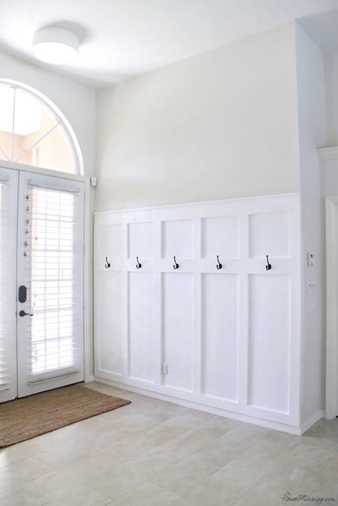 Entryway with white board and batten  half wall and hooks