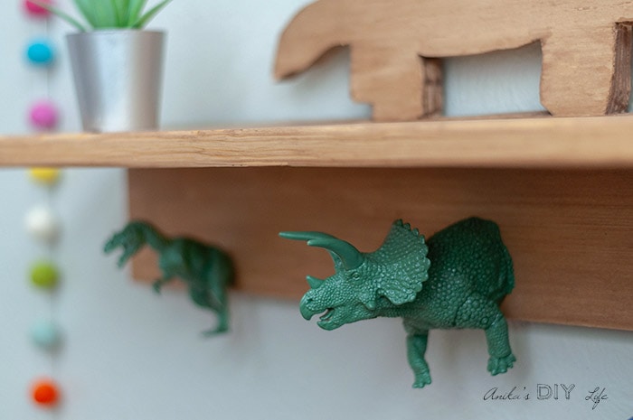 close up of dinosaur hooks on the dinosaur shelf