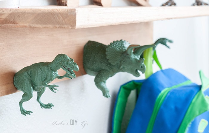 close up of DIY dinosaur shelf hooks