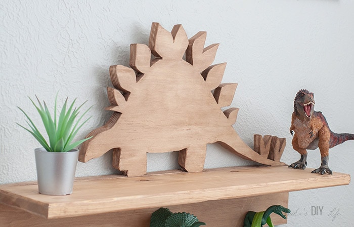 Close up of Wooden dinosaur cutout on DIY dinosaur shelf