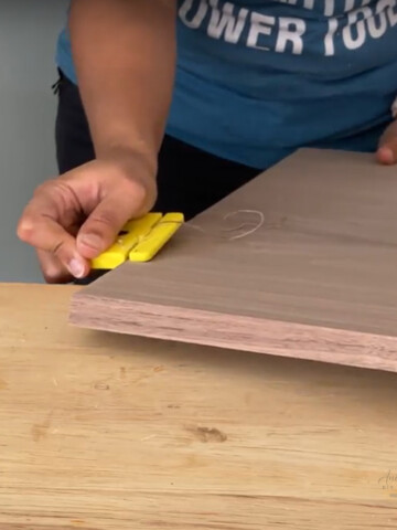 woman cutting edge banding with trimmer