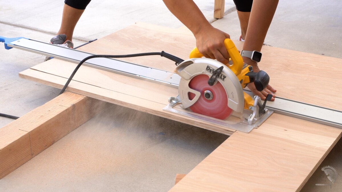 cutting plywood with circular saw on the ground