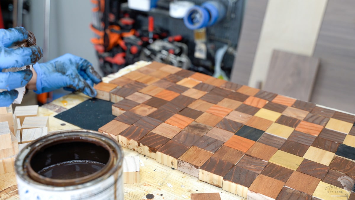staining and arranging scrap wood blocks for table runner