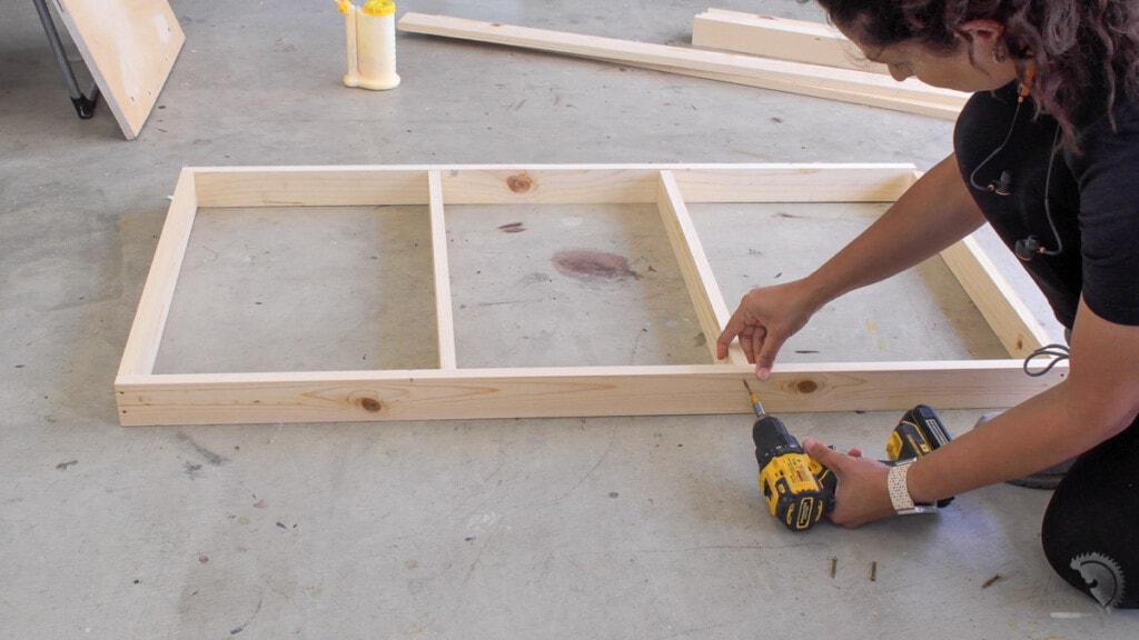 Woman building the frame for the DIY cornhole boards