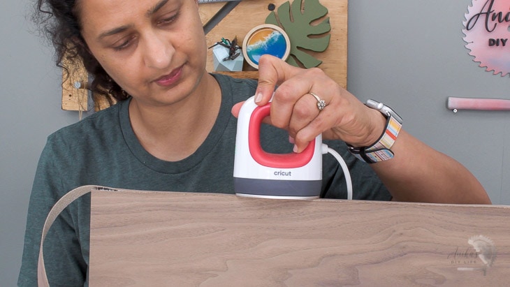 Woman applying edge-banding to plywood using the EasyPress Mini