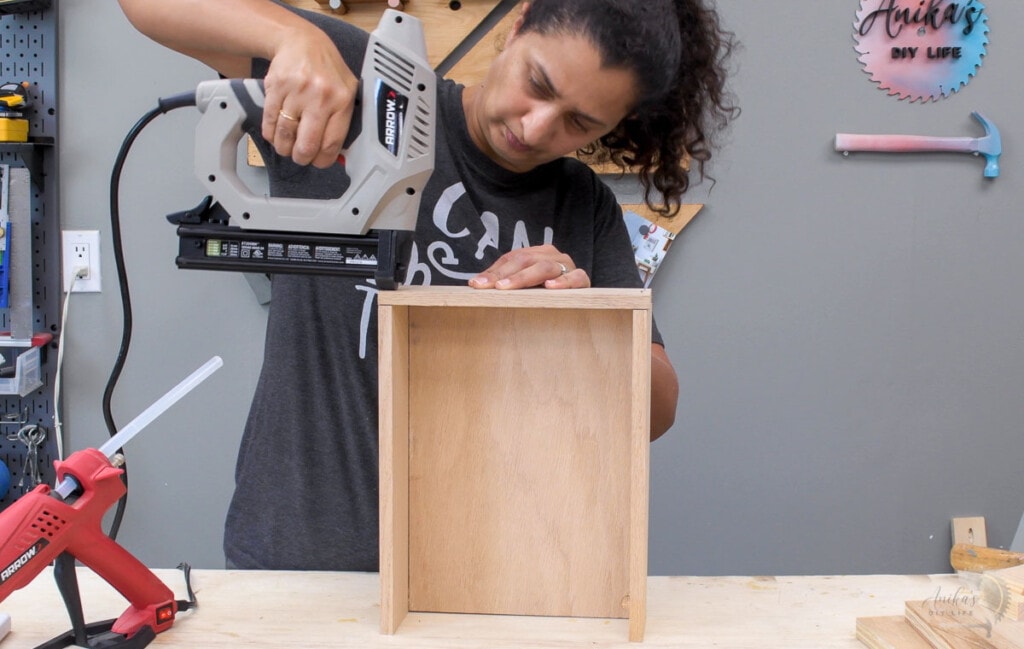 Woman building the box for the DIY device charging station