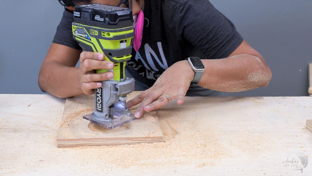 woman routing plywood to accomodate the wireless charger 