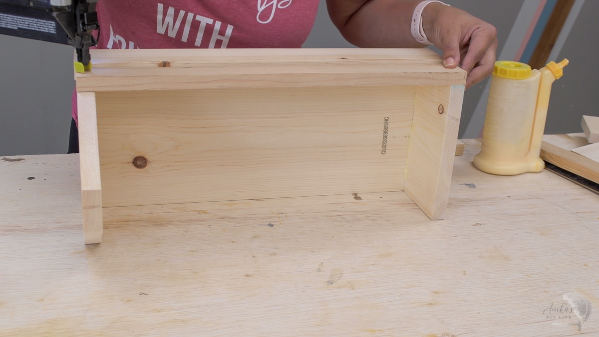 woman attaching the sides to make a tool box