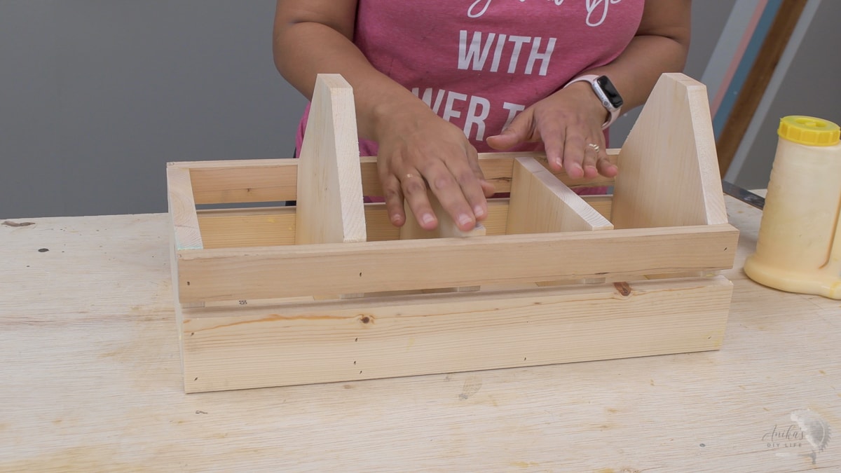 woman adding dividers in. the tool box 