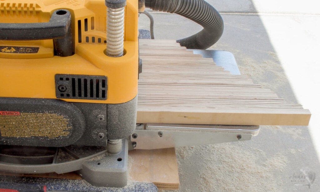 Sanding down the glued up plywood using a planer.