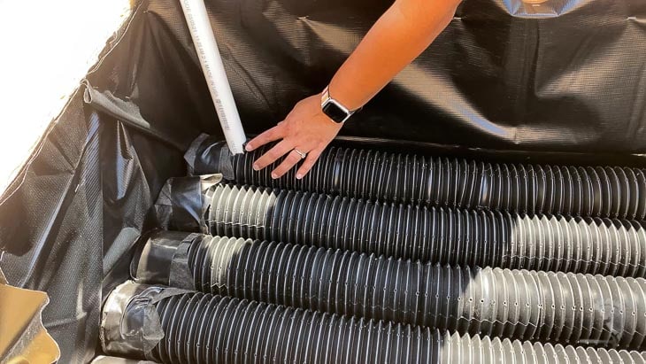Adding the PVC pipe to one of the corrugated perforated pipes