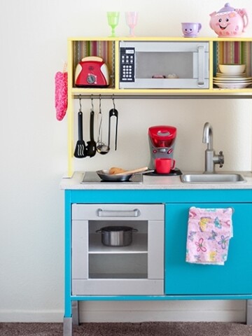 This Ikea Duktig Kitchen hack takes the plain Ikea kitchen and transforms it into a fun and colorful kids play kitchen with just a bit of paint and paper!