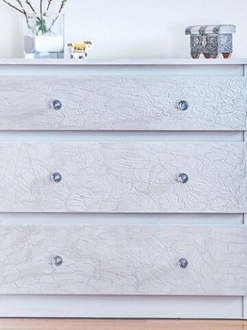Ikea Malm dresser hack with a unique cracked paint effect. This easy technique transforms a drab Ikea Malm dresser into super glam and chic!