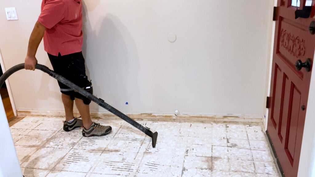 vacuuming the floor before installing vinyl plank flooring