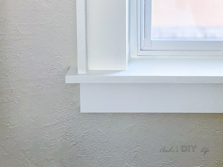 close up of corner of window with DIY trim