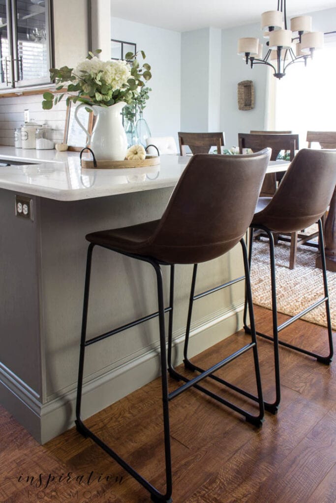 close up of kitchen island trim molding and brown bar stools