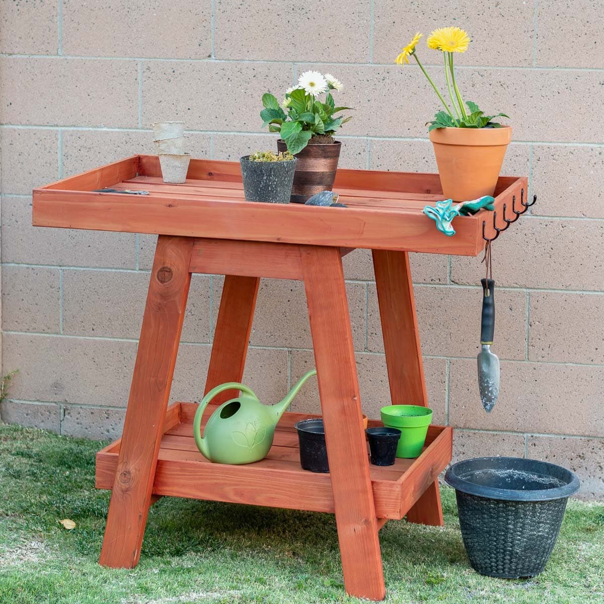 Learn how to build this simple and modern DIY potting bench with a step-by-step tutorial and plans. It can also double as a plant display or console table. Great beginner woodworking project.