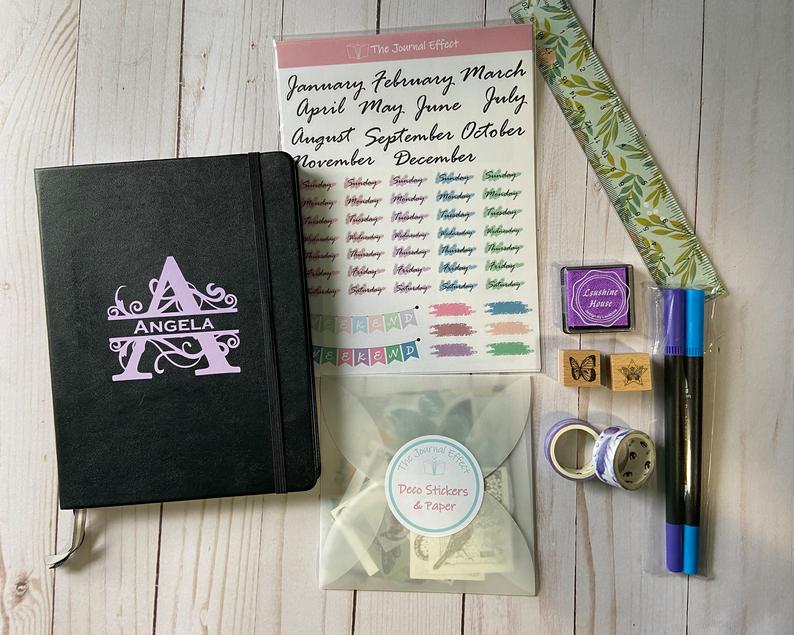 personalized bullet journal with stickers, stamps, ruler and pens