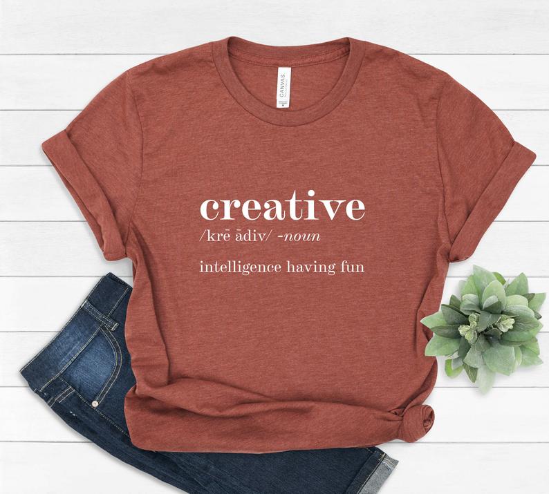 Red t-shirt with text creative /kre adev/ noun intelligence having fun