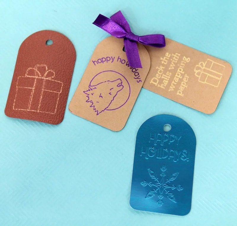 Gift tags made with Cricut using leather, foil, and card stock.