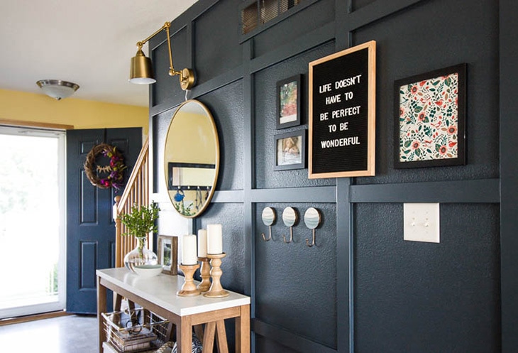 Navy blue board and batten in living room next to stairs