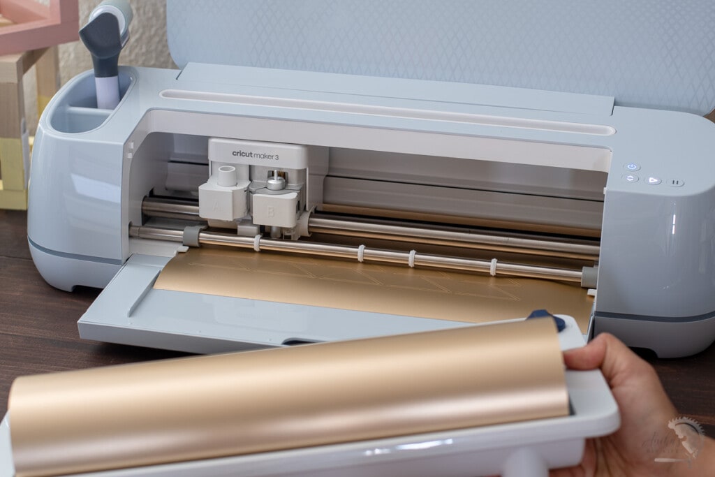 Woman removing the roll holder from the Cricut Maker 3